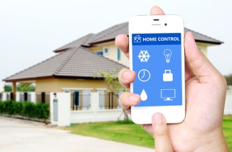 Hand holding mobile smart phone with smart home application on s
